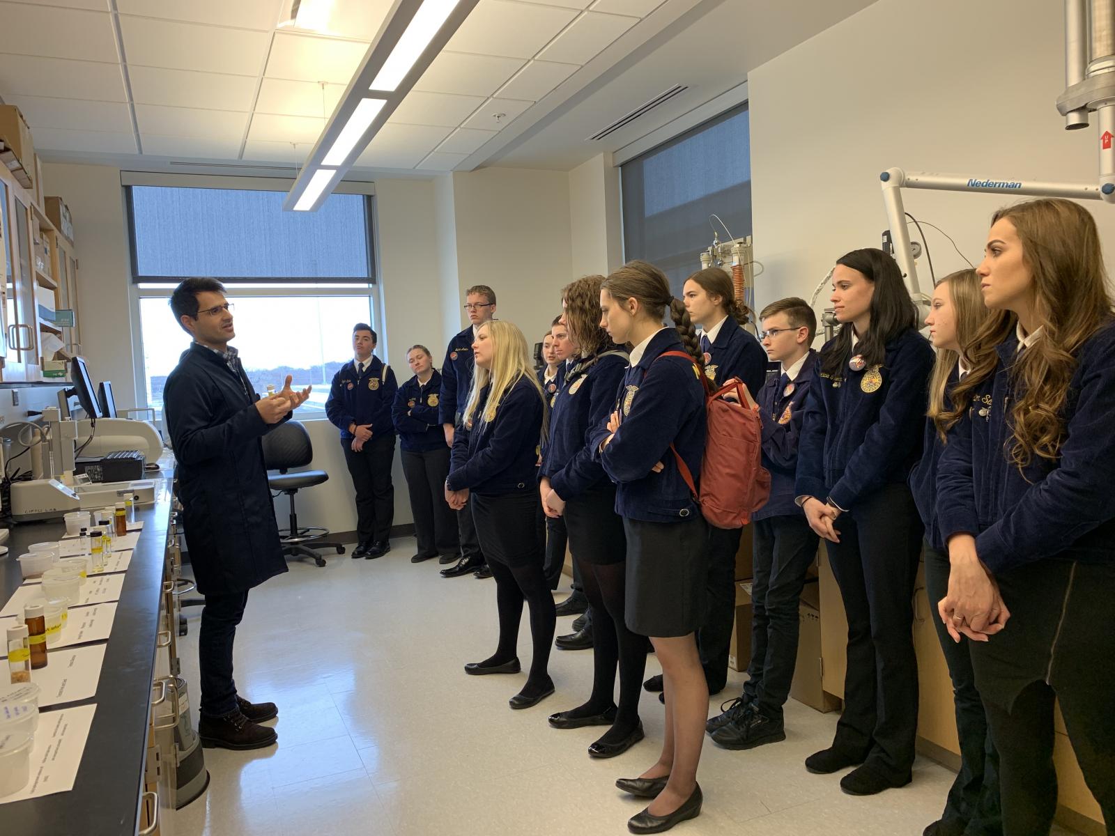 Felipe explaining his research to high school FFA students
