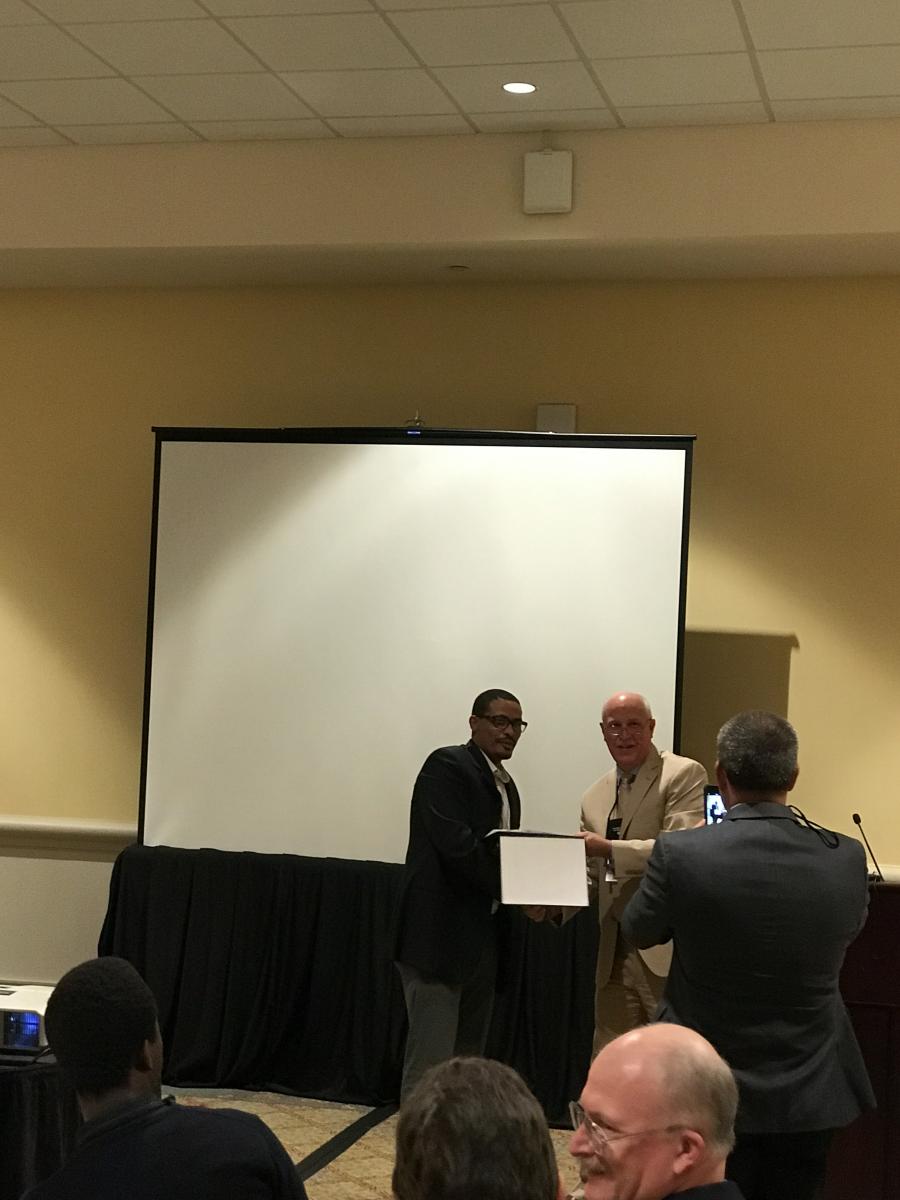 Henok while receiving the American Oil Chemists Society (AOCS) 2017 Processing Division Student Excellence Award at the 108th AOCS Annual Meeting and Expo in Orlando, FL
