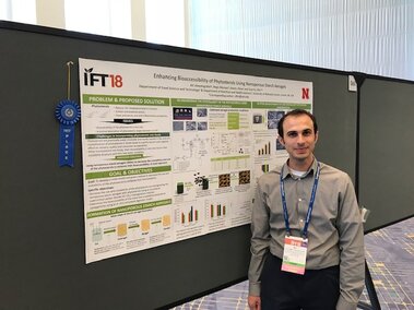 Ali while receiving the 1st place at IFT18 Student Research Paper Poster Competition.