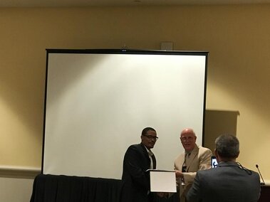 Henok while receiving the American Oil Chemists Society (AOCS) 2017 Processing Division Student Excellence Award at the 108th AOCS Annual Meeting and Expo in Orlando, FL