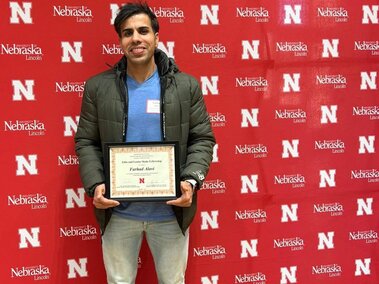 Farhad holding his Skala Fellowship certificate