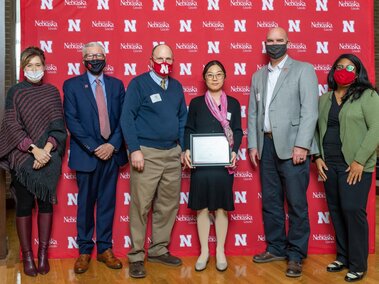 Lingyi holding her 2021 Skala Fellowship certificate with Drs. Weller, Heng-Moss, and Clutter