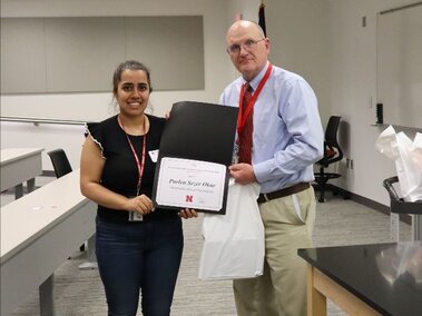 Purlen receiving her award at the FDST Research Symposium.