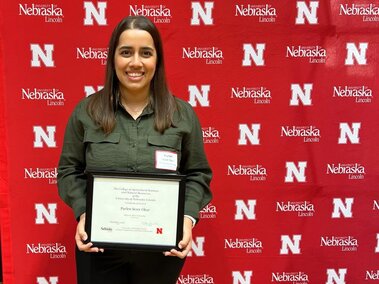 Purlen holding her Milton E. Mohr Fellowship certificate.